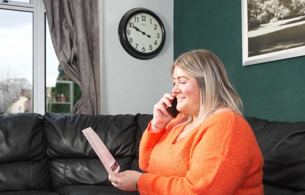 A customer speaking to an adviser on the phone about their home energy work